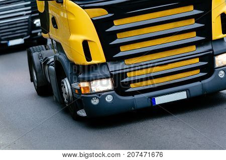 Trucks being driven on road picking up goods