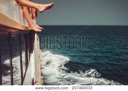 Young people chilling in catamaran boat - Relaxed people making tour ocean trip - Travel, summer, friendship, tropical concept. Only legs close up. Retro vintage toning effect