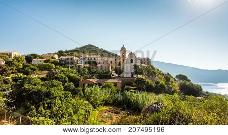 Church in small Corsica town sea and grass