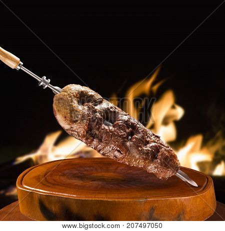 Alcatra traditional Brazilian barbecue. fire in background