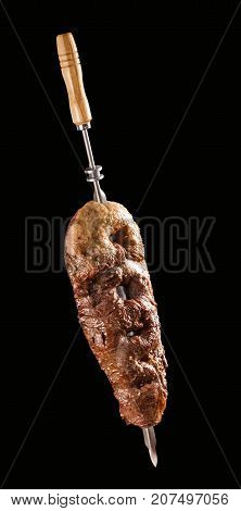 Alcatra traditional Brazilian barbecue. Black in background