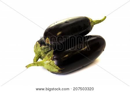 Three purple eggplants on white background isolate