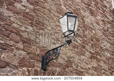 Black old latnern hanging on a wall