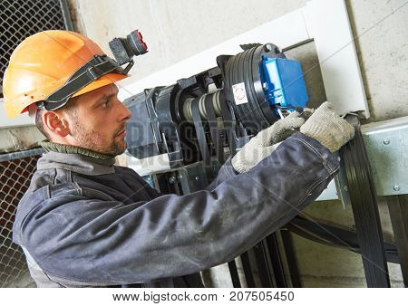 lift machinist repairing elevator in lift shaft