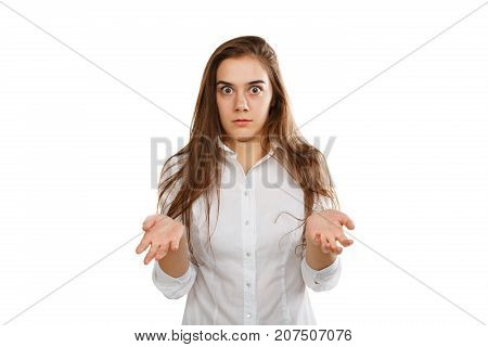 Close-up portrait of a young beautiful girl in a white blouse with long flowing hair. Which does not know what to do.