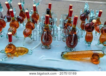 Aromatic homemade brandy in souvernir bottles on traditional market