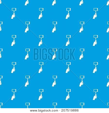 Hand holding a selfie stick with mobile phone pattern repeat seamless in blue color for any design. Vector geometric illustration