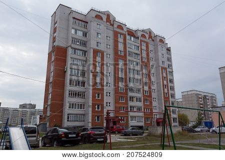 Yoshkar-Ola, Russia - October 5, 2017 Photo of a multi-storey brick house made of white and red brick, built in the 1990s in Yoshkar-Ola, Russia