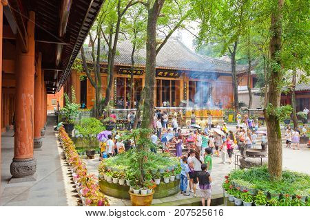 Leshan July 2011 - In July many visitors come to see this site of the world most impressive religious statue to enjoy also the garden and the temple of this UNESCO site. Many visitors while are visiting the temple light many candles