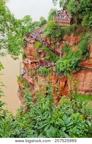 Leshan July 2011 - In July many visitors come to see this site of the world most impressive religious statue to enjoy also the garden and the temple of this UNESCO site. The visitor must get down the mountain stairs to reach the feet of the Buddha