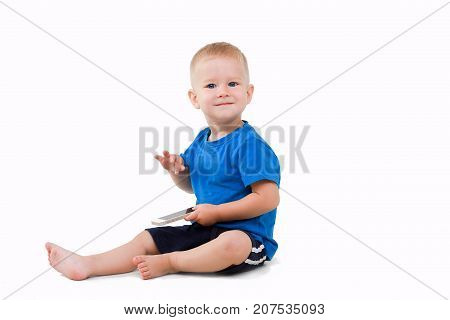 a happy baby is playing on a smartphone