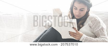 Girl Reading Book On Sofa