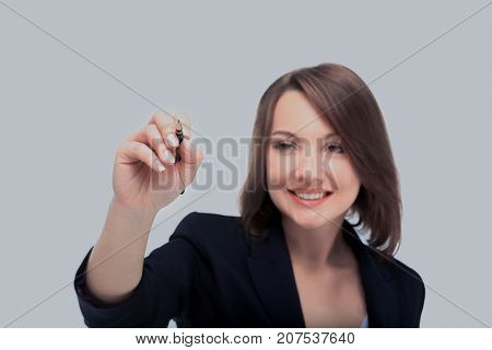 Young businesswoman with pen isolated on white background