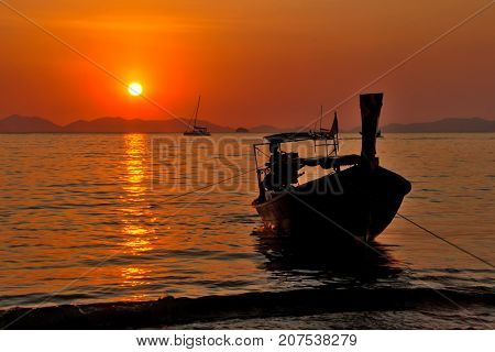Fisherman returns from the sea at sunset. Railay Beach. Krabi, Thailand.
