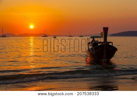 Fisherman returns from the sea at sunset. Railay Beach. Krabi, Thailand.