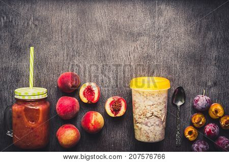 Fruit Smoothies. Peach and plum smoothie. Peach, plum and oatmeal. Delicious and healthy breakfast on wooden background. Top view. Copy space. Still life. Flat lay