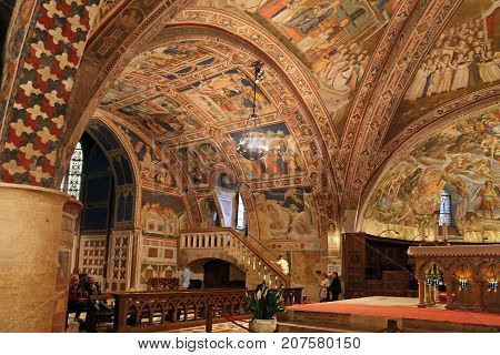 ASSISI ITALY 30 JUNE 2017: Interior Famous Basilica of St. Francis of Assisi (Basilica Papale di San Francesco) with Lower Plaza at sunset in Assisi Umbria Italy