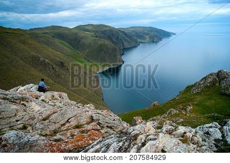 Girl lost in landscape in lake Baikal, Aya bay.