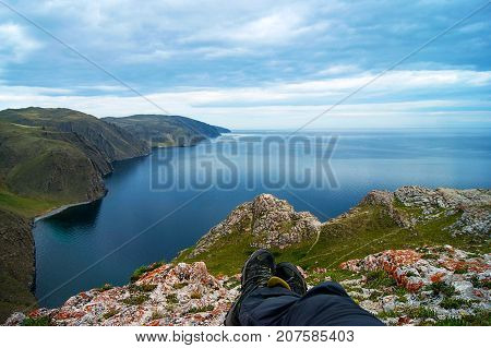 Men boots with lake Baikal on the background