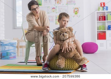 Sad Boy Hugs Teddy Bear