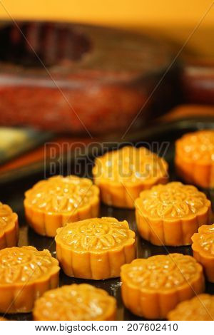 close-up group of moon cake on metal tray and wooden mold, home made Moon cake, traditional dessert made from du-rian for Chinese mid autumn festival, gourmet asian restaurant