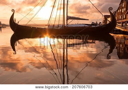 Seafront on the sunset with Viking ship