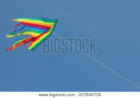 big colored kite flying high in the sky symbol of freedom and joy