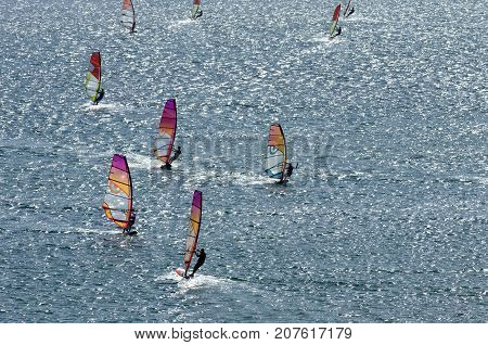 Windsurfers on the sparkling waves of the Mediterranean sea at Cape Prasonisi (Greece)