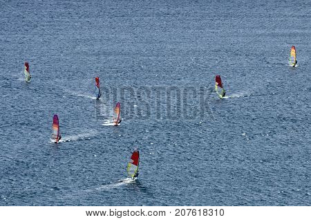 Windsurfers on the sparkling waves of the Mediterranean sea at Cape Prasonisi (Greece)