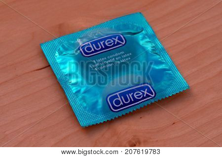 Almere, The Netherlands - October 6, 2017: Durex condom against a wooden background.