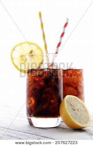 Softdrink With Ice Cubes, Lemon And Straw In Glass