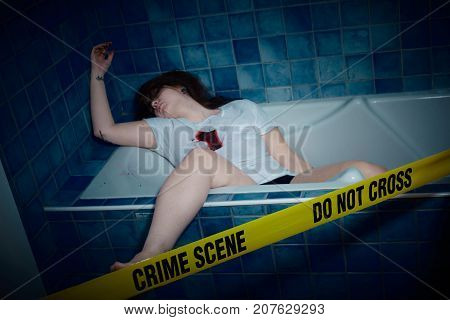 young woman lying dead in a bath tub