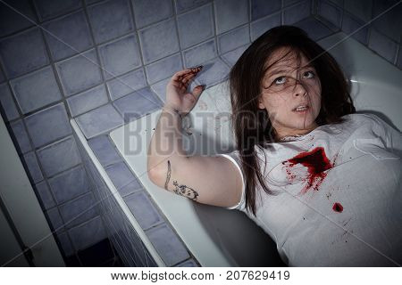 young woman lying dead in a bath tub