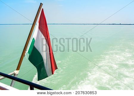 Hungarian Flag At The Cruise Ship With Bright Light Blue Water Of Balaton Lake At The Background Hun