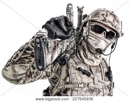Half length low angle studio shot of special forces soldier in field uniforms and face mask with sniper rifle on his shoulder, portrait isolated on white background