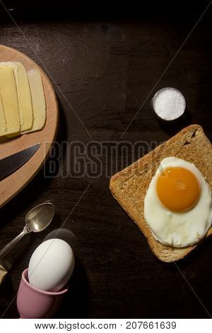 Breakfast option with egg on a black wooden board