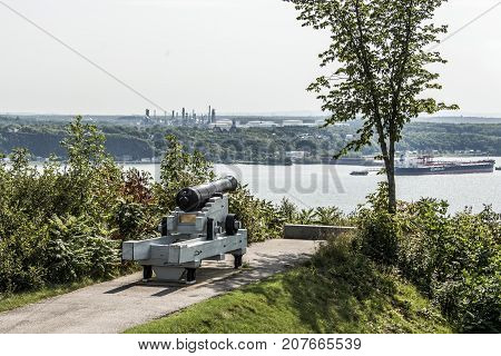 Quebec City Canada 11.09.2017 Cannon in Quebec City Canada - plaines Abraham overlooking Saint Lawrence river and Jean-Gaulin Refinery in Levis town
