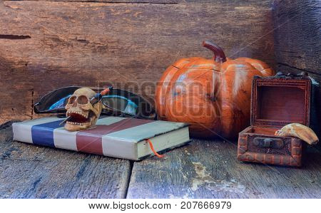 skull on book in Halloween day concept on old vintage wooden background. still life style with copy space add text ( full High definition Photo)