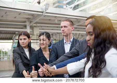 Businessmen thumb up to celebrate achievement and success