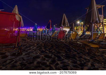 beach by night with deckchairs on crete greece