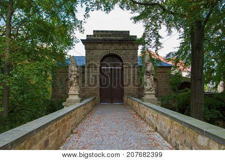 A square photo of closed ancient wooden catle door guarding the entrance to the medieval castle. Vajdstejn Cesky Raj Czech Republic