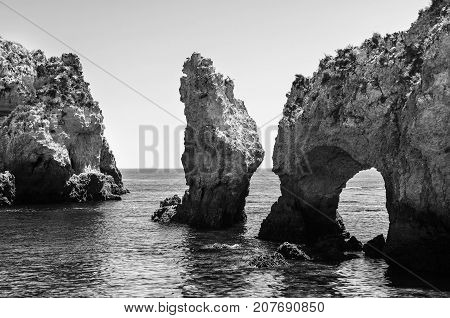 Algarve coastline in Portugal. Rocks and Sea in Lagos, Algrave, Portugal. Black and white