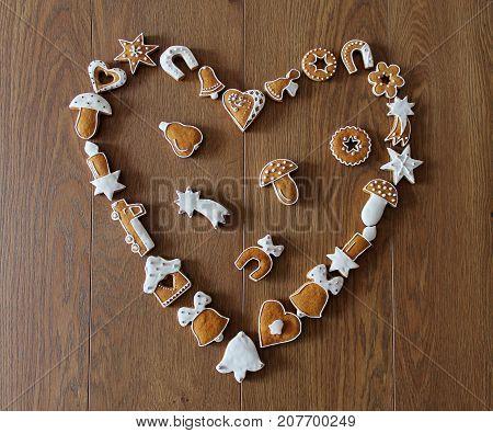 Christmas background with cookies on the wooden board (heart shape frame)