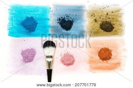 six samples of bright dry pigment with a brush isolated on white background with copyspace