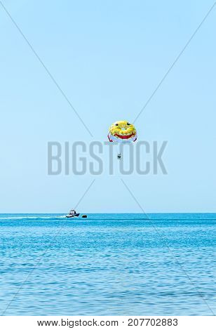 ALBENA BULGARIA - JUNE 15 2017: Colored parasail wing pulled by a boat in the sea water Parasailing also known as parascending or parakiting.
