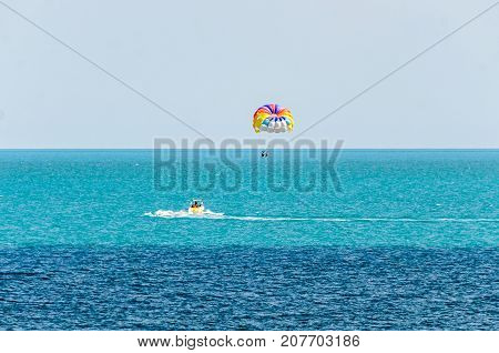 Colored Parasail Wing Pulled By A Boat In The Sea Water, Parasailing Also Known As Parascending Or P