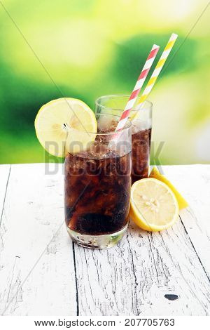 Softdrink With Ice Cubes, Lemon And Straw In Glass
