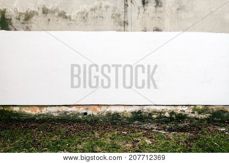 Aged weathered brown and white street wall with afresh layer of paint