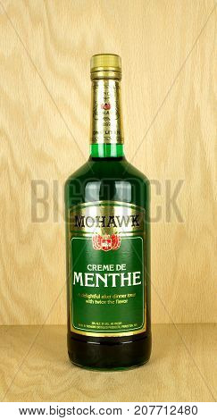 RIVER FALLS,WISCONSIN-OCTOBER 07,2017: A bottle of Mohawk brand Creme De Menthe with a wood background.