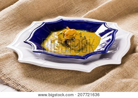 Pequi Fruit With Chicken Over A Wooden Table. Frango Com Pequi.